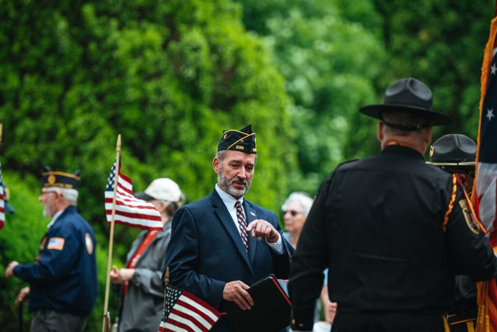 Photo by Chris F from Pexels: https://www.pexels.com/photo/men-in-suit-and-uniforms-and-with-flags-in-ceremony-26225440/